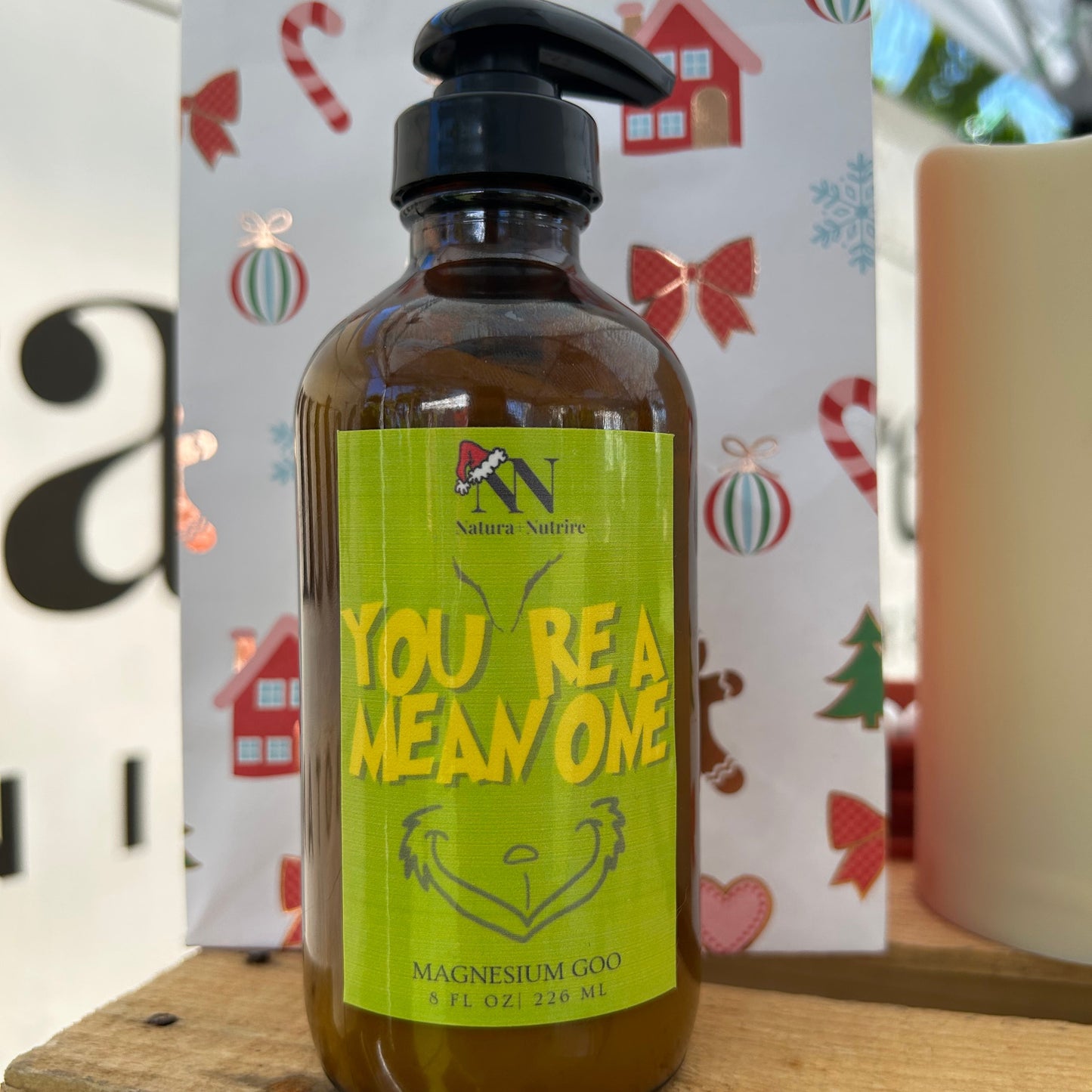 Bottle of 'You're a Mean One' soap with a colorful background