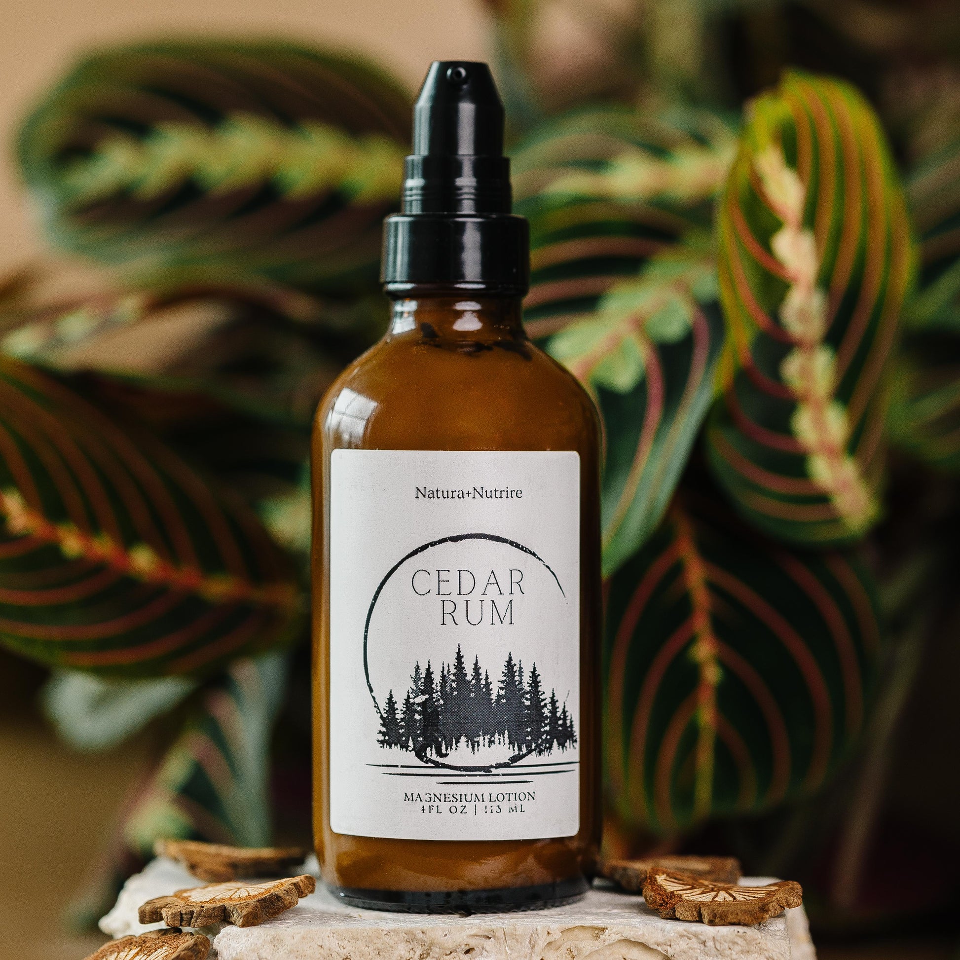 Bottle of Cedar Rum with a label on a stone surface with leaves in the background