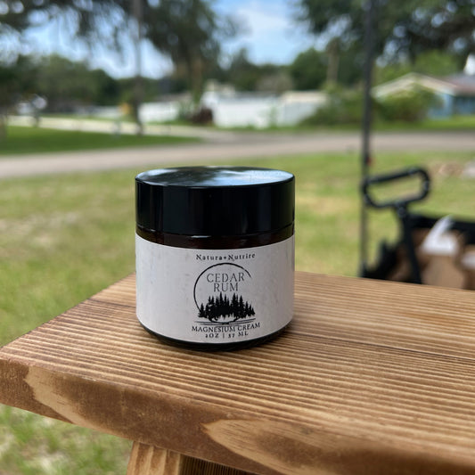 Jar of cream on a wooden surface with a blurred outdoor background