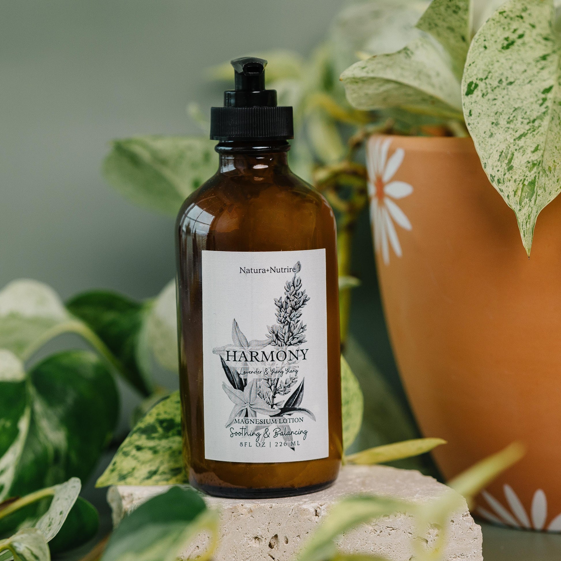 Brown bottle labeled 'Harmony' with a plant in the background