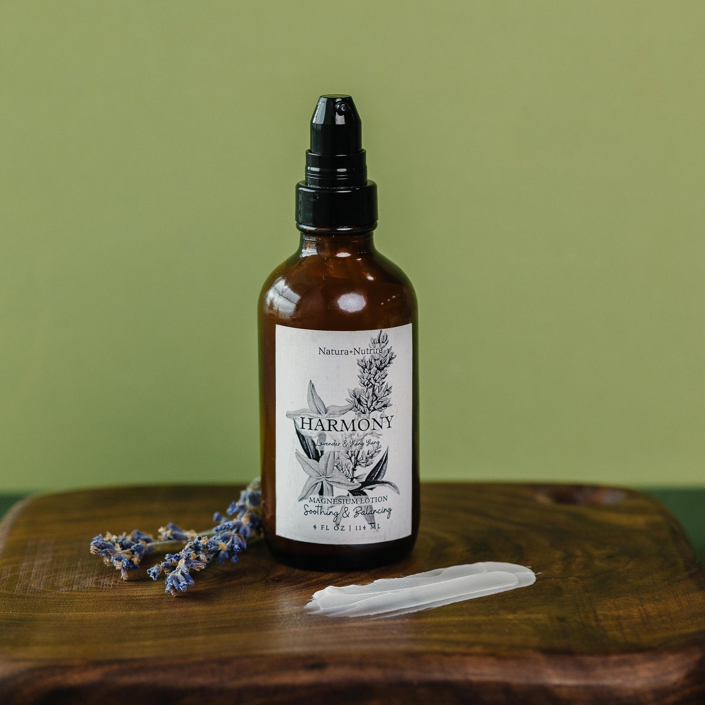 Bottle of 'Harmony' with a dropper on a wooden surface against a green background
