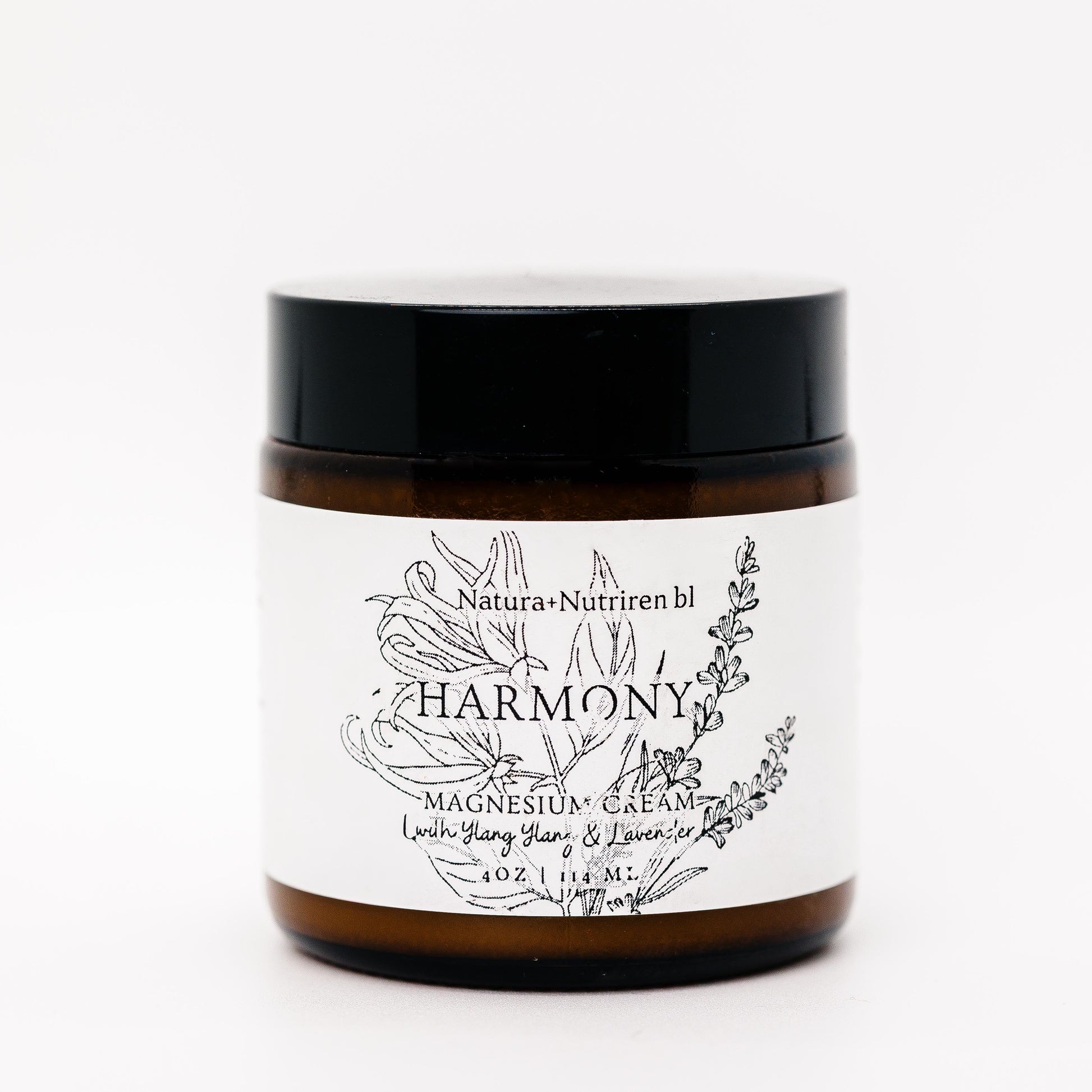 Jar of 'Harmony' magnesium cream with a black lid on a white background