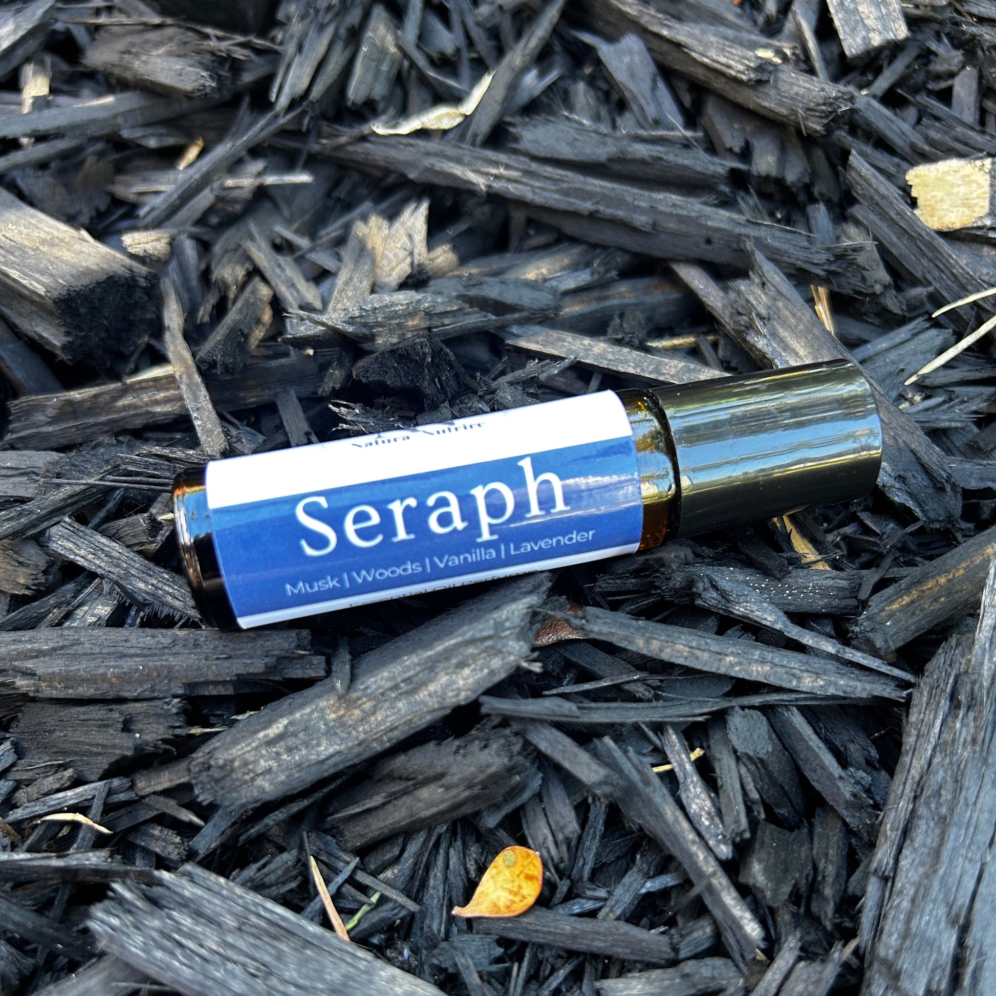 Seraph bottle on a bed of dark wood shavings
