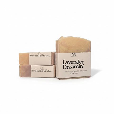 Lavender Dreamin' Handcrafted Soap bars with kraft paper labels, boxed and unboxed, on a white background