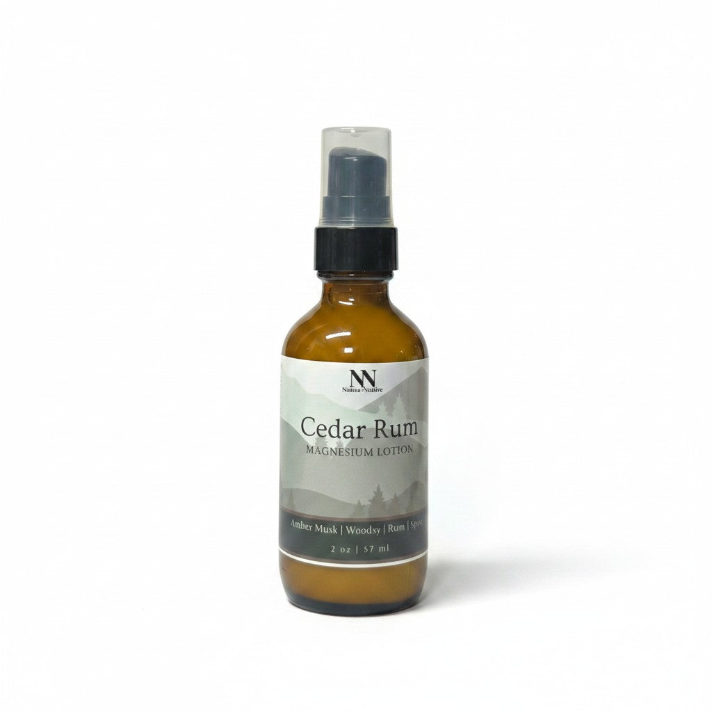 Cedar Rum Magnesium Lotion 2oz spray bottle with green and gray mountain-patterned label on a white background