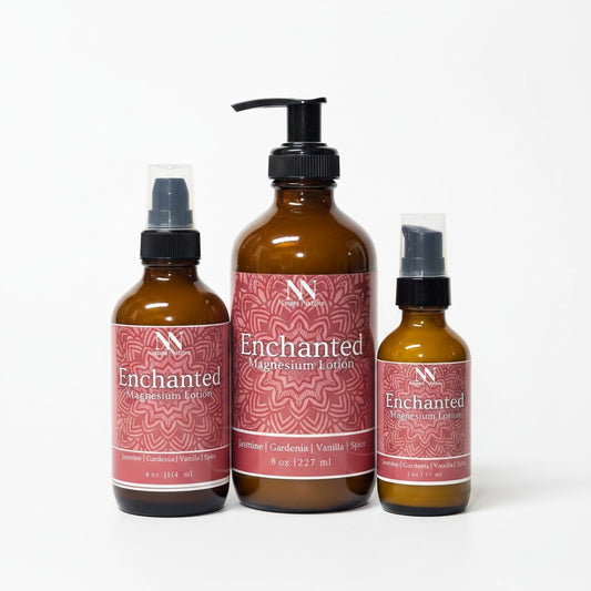 Three Enchanted Magnesium Lotion bottles - 4oz spray, 8oz pump, and 2oz spray - with pink mandala-patterned labels on a white background
