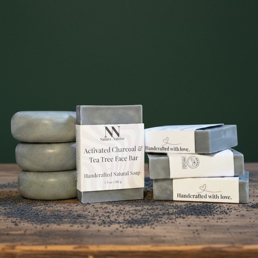 Stacks of natural soap bars with visible branding on a wooden surface against a green background