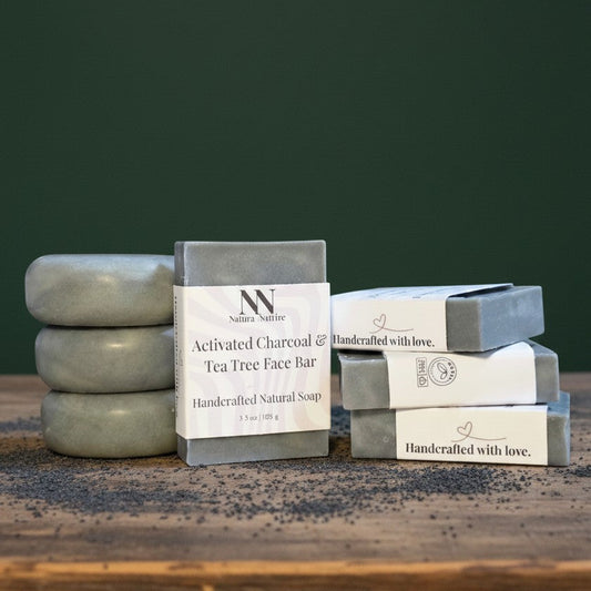Stacks of natural soap bars with visible branding on a wooden surface against a green background