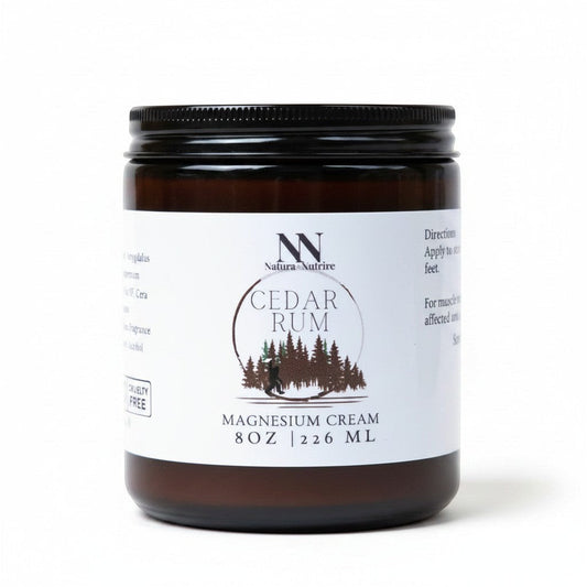 Natura+Nutrire Magnesium Cedar Rum muscle relief cream in an 8oz amber glass jar with a black lid.