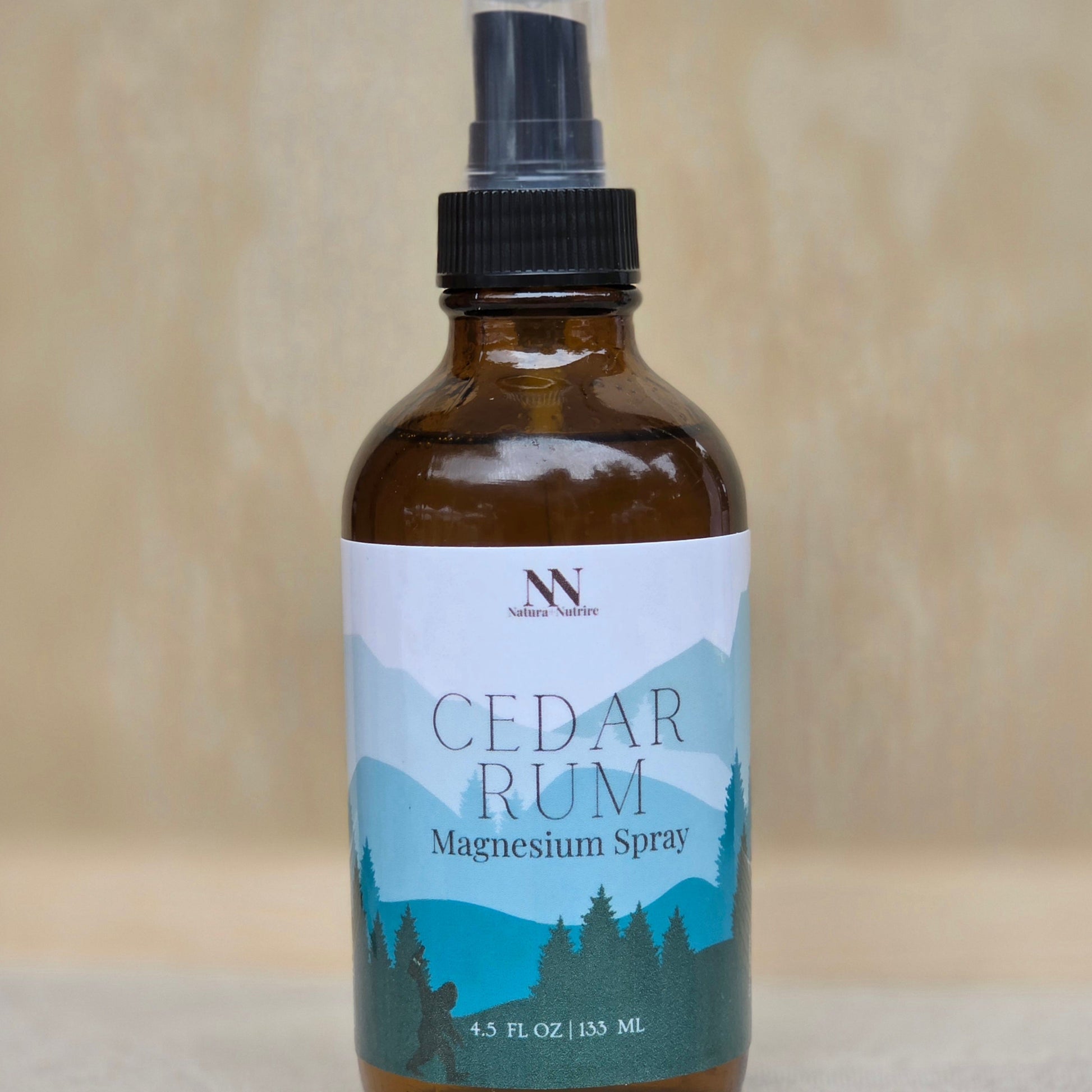Bottle of Cedar Rum Magnesium Spray with a label on a neutral background
