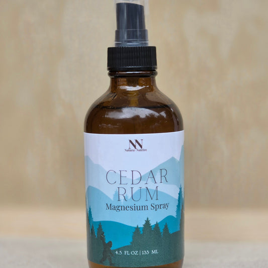 Bottle of Cedar Rum Magnesium Spray with a label on a neutral background